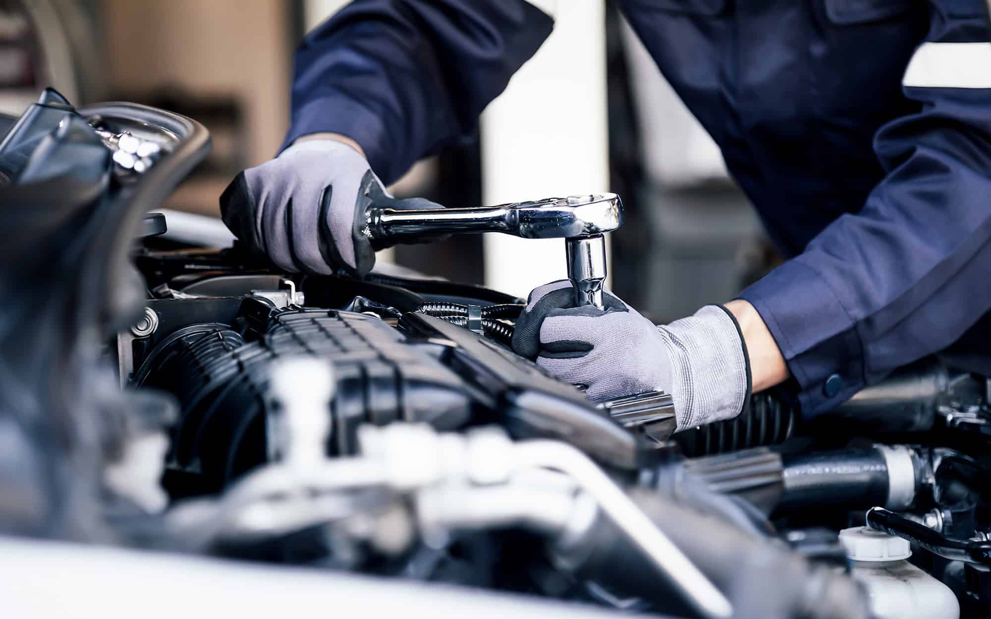 Professional mechanic working on the engine of the car