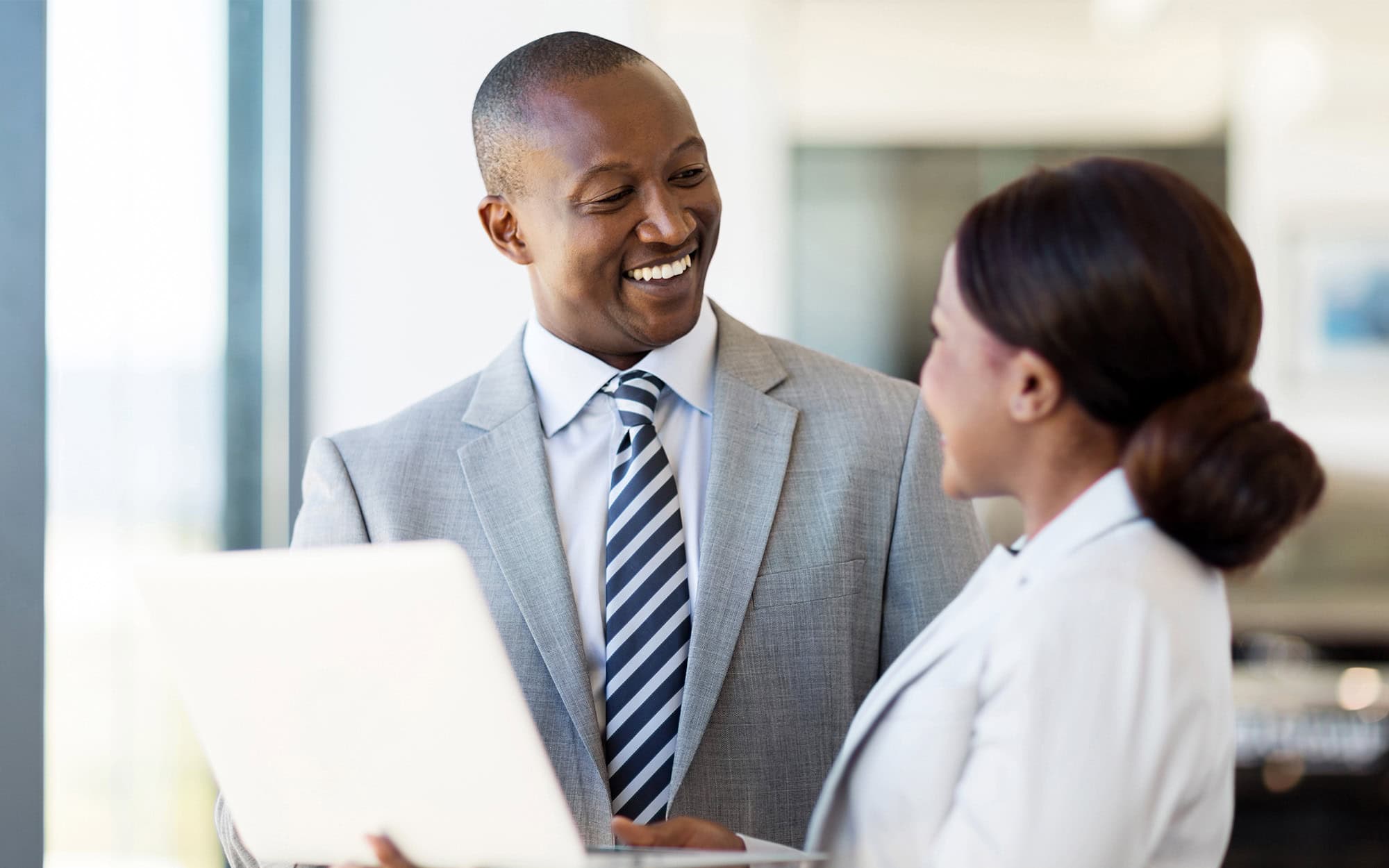 Two people in office smiling