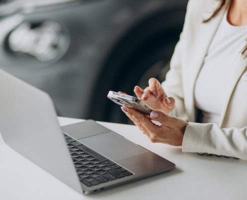 Business woman working on a laptop at the office of car showroom