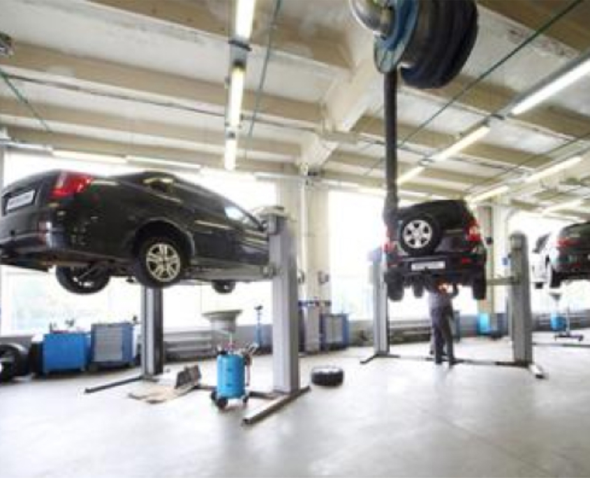 Side view of cars on risers at dealership