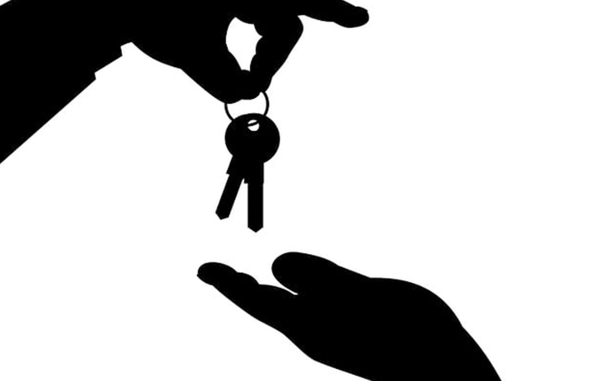 Two silhoutetted hands giving over a key