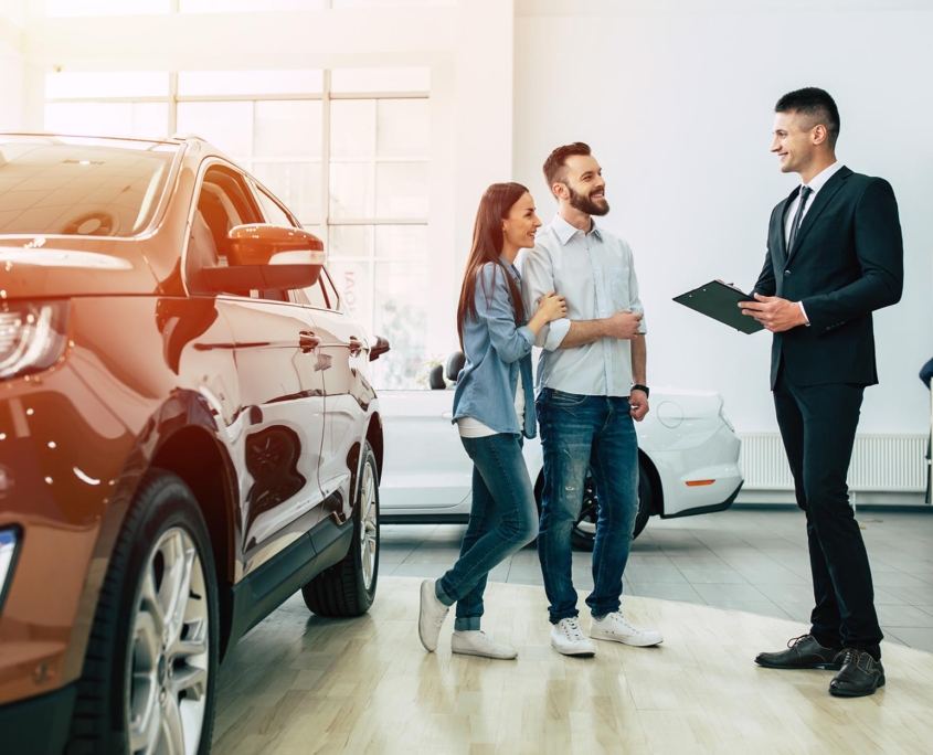 Business person selling car at dealership