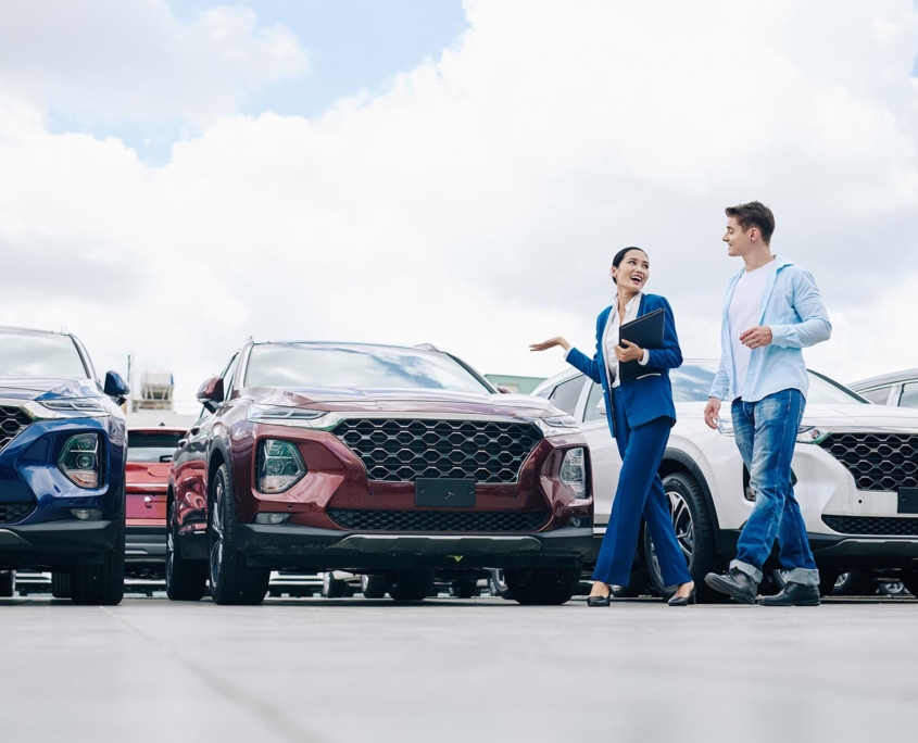 Car salesman walking through lot with potential buyer