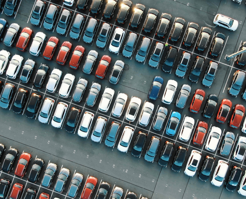 tight coloured car rows on parking area vertical upper view