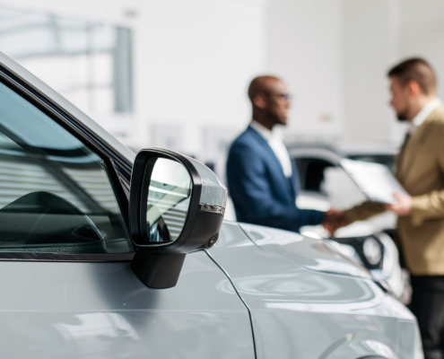 An auto dealer closes a deal or a successful consultation