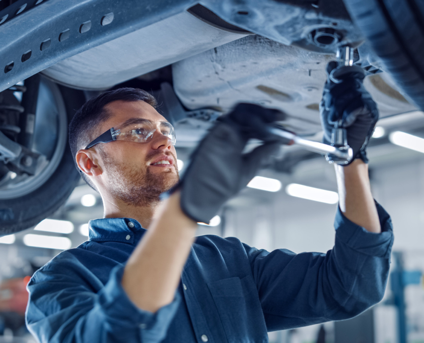 Portrait Shot of a Handsome Mechanic Working on a Vehicle in a Car Service Portrait Shot of a Handsome Mechanic Working on a Vehicle in a Car Service